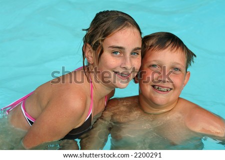 Retro Brother And Sister Splashing In Pool High-Res Stock 