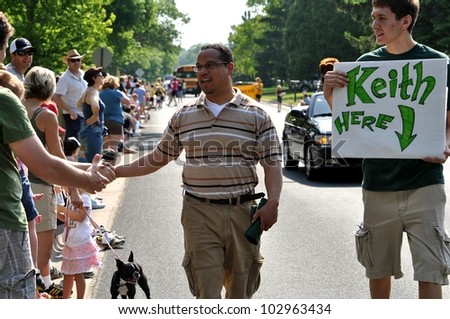 GOLDEN VALLEY, MN. - MAY 19:  Congressman Keith Ellison greets parade spectators at the Golden Valley Days Parade on May 19, 2012 in Golden Valley, Minnesota.