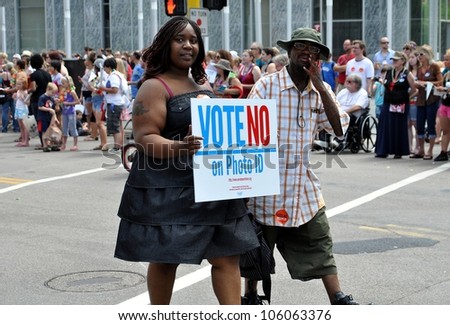 MINNEAPOLIS - JUNE 24:  Supporters of a No vote on Photo ID march in the Gay Pride Parade on June 24, 2012, in Minneapolis.  A Photo ID requirement for voting will be on the ballot in Mn. in November.