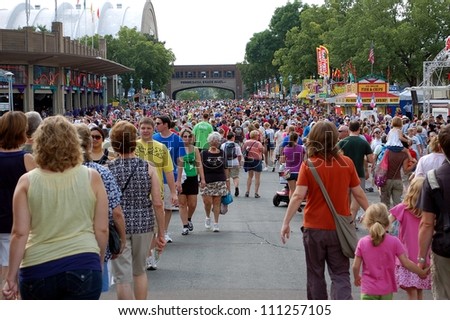 ST. PAUL - AUGUST 26:  Large crowds fill the street at the Minnesota State Fair on August 26, 2012, in St. Paul.  Attendance is averaging 139,000 per day in 2012.