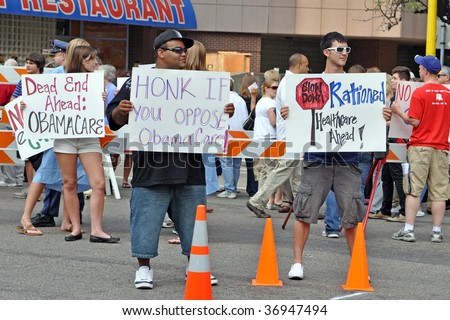 MINNEAPOLIS - SEPTEMBER 12: Health Care Reform protesters hold placards outside of Barack Obama\'s Health Care speech at the Target Center on September 12, 2009 in Minneapolis.