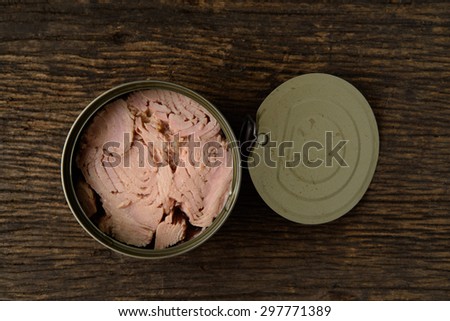 canned tuna on a wooden table