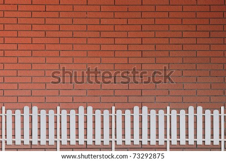 bricks wall and white fence
