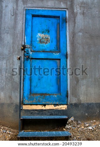 Cool blue door on a rustic industrial building