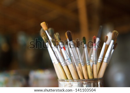 Old paint brushes in cans.
