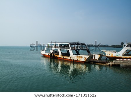 TRAT, THAILAND - DECEMBER 30: The Koh Chang ferry pier and ferry going to Koh Chang island on DECEMBER 5, 2013 in Trat, Thailand. The ferry transports thousands passengers daily