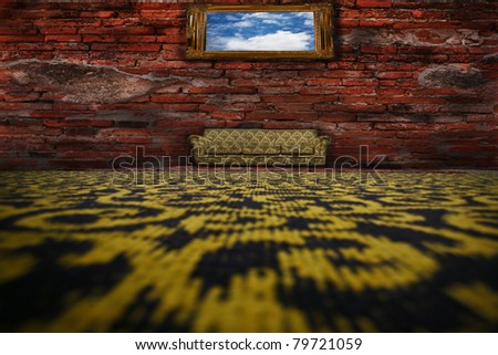 Sofa, rug on the floor in front of a brick wall.