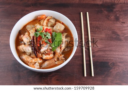 Tom Yum Kung Thai popular menu spicy soup with chopstick
