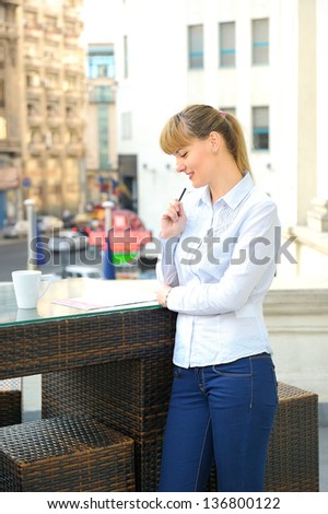 young attractive businesswoman working in a restaurant terrace