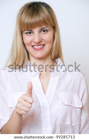 Happy smiling business woman showing thumbs up gesture