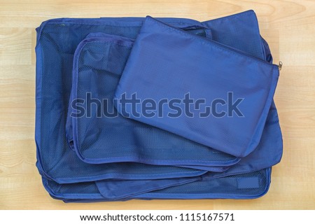 Different blue cube bags, set of travel organizer to help packing luggage easy, well organized
