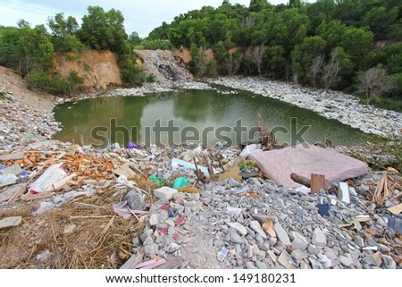 CHONBURI, THAILAND - JULY 14 : A mountain of dirty trash surrounding the lake in Chonburi Province on the 14th of July 2013.