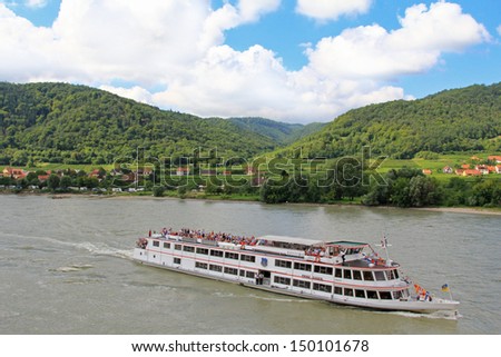 WACHAU, AUSTRIA - AUGUST, 2012 : Tourists cruises along the Danube river, Wachau, Austria on August 12, 2012.