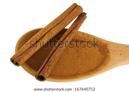 Cinnamon sticks on a spoon of Cinnamon powder
