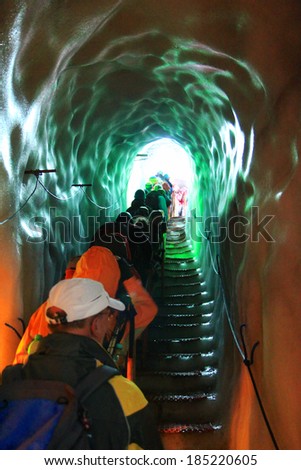 AUSTRIA - AUGUST, 2012 : Explorers walking inside the Crevasse - Natural Ice Palace (Ice Cave) inside the  Hintertux Glacier, by using steps and ladders on August 15, 2012.