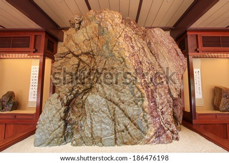 HONG KONG - JANUARY 2014 : A huge rock showing at the Rockery museum at Nan Lian Garden, in Diamond Hill, Hong Kong on January 1, 2014. The rock is from Red River of Guangxi Province in China