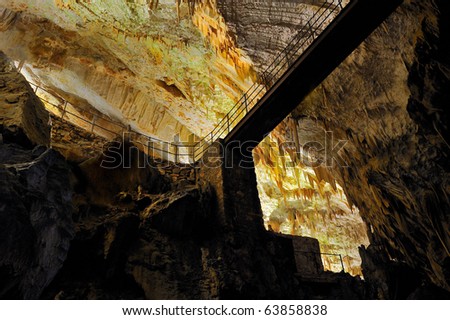 Stalactites, stalagmites and bridge in an underground cavern - Postojna cave
