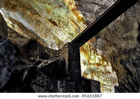 Bridge, stalactites and stalagmites in an underground cavern - Postojna cave
