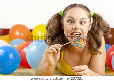 Young woman having fun playing with balloons and goofing around