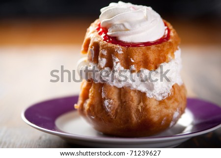 Cream puff drizzled with whipped cream