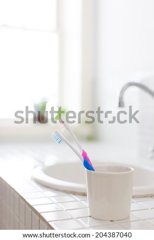 Toothbrush and placed in wash basin.
