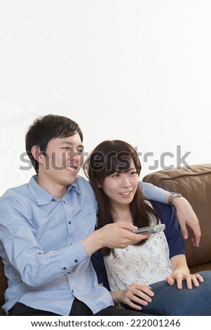 Young couple that watching sports on TV.