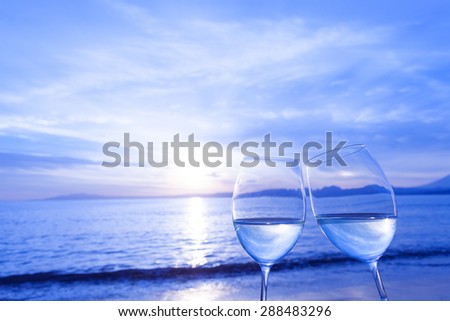 Wine glass and dusk of beach