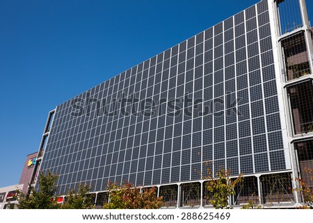 Solar panels installed on the outer wall of commercial buildings