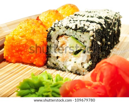 rolls with black roe and sesame and baking sushi on bamboo mat