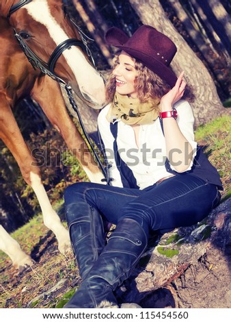 Beautiful  cowgirl with her red horse