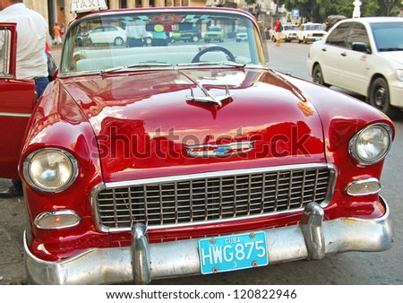HAVANA - JANUARY 29: a red classic 55 Chevy Bel Air car in Havana, Cuba on January 29, 2009. Many Cubans maintain classic American cars due to the ban on car trading since the Revolution in 1959.