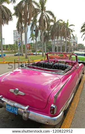 HAVANA - JANUARY 29: A pink Buick parked outside the Hotel Nacional de Cuba in Havana on January 29, 2009. American classic cars are often used as taxis for tourists in Havana.