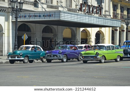 Havana - July 31: classic cars parked outside the historic Payret cinema in Havana, Cuba on July 31, 2014. Historic buildings and the vintage cars are a major tourist attraction in Havana.
