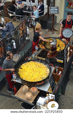 London - September 13: chefs cooking paella at a restaurant in Covent Garden, London, UK on September 13, 2014. The old market is now a major tourist attraction with shops, pubs and restaurants.