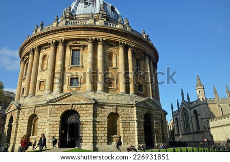 Oxford, UK - October 27, 2014: view of the Radcliffe Camera with All Souls College in Oxford, UK. The historic building is part of Oxford University Library.
