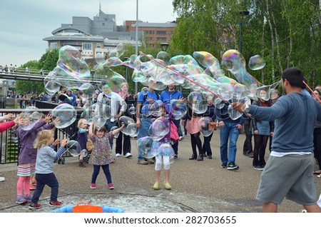 London, UK - May, 24: a street performer makes soap bubbles for children on the Embankment in London, UK.