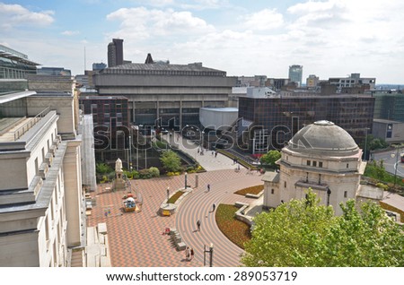 Birmingham, UK - June 16: view across Centenary Square with the Hall of Memory and old central library in Birmingham, UK on June 16, 2015. The old library is due to be demolished.