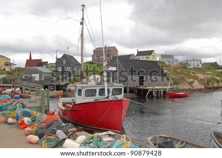 boats and fishing equipment on quayside in canadian fishing village