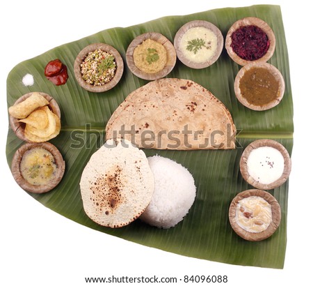 South indian lunch including rice, chapatti and curries on banana leaf with clipping mask