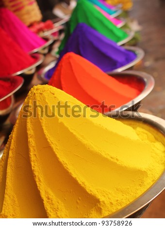 Colorful piles of powdered dyes used for holi festival on display in an indian shop at mysore