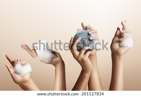 woman hands with a soap foam on a beige background