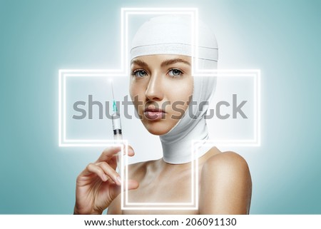 beauty woman with bandaged head holding injection. Glowing cross