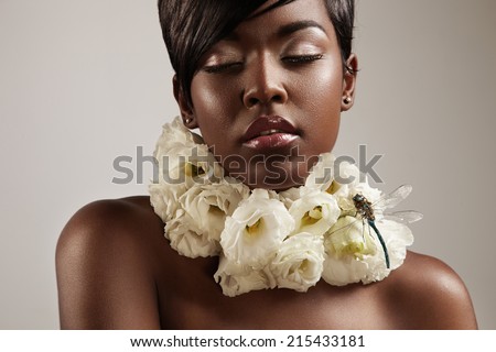 beauty black woman with flowers on her neck.