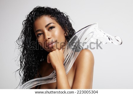 beauty latin woman with a wet hair and a plash of a water