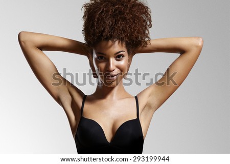 black woman hands up showing armpits