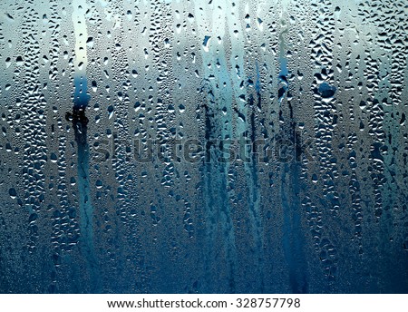drops on the glass ,rain, the rain outside the window,
