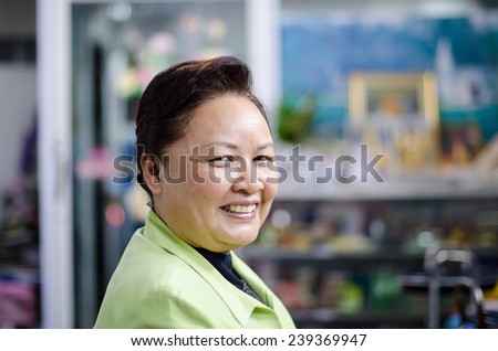 a good looking middle age Asian woman in the haircut shop