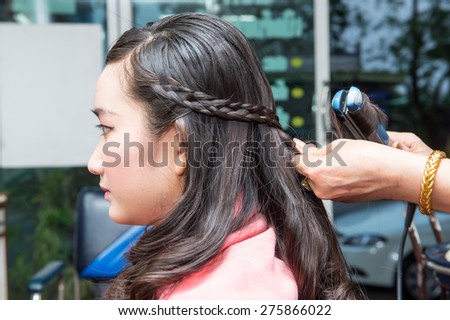 Asian young teenager hair braid in the beauty salon