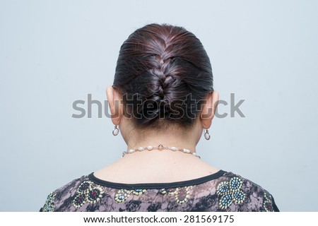 the back view of a middle aged Asian woman hair braid