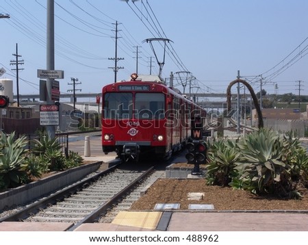 Red trolley pulling into a station, bound for San Diego\'s Gaslamp district